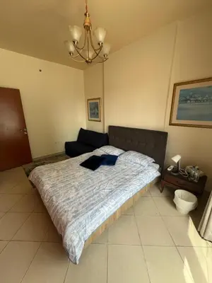 a bedroom with a large bed and a couch at Marina Diamond in Dubai