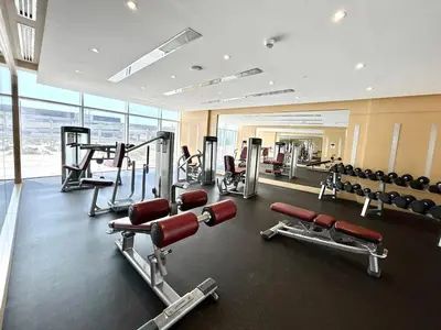 a gym with cardio equipment in a building at Homes2Retreat - Chic & Cozy Studio in Damac in Dubai