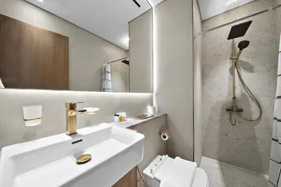 a bathroom with a sink and a toilet and a shower at FIRST CLASS Studio Touch of Luxury & Comfort in Dubai