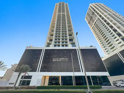 a tall building with two tall buildings at FIRST CLASS Studio Touch of Luxury & Comfort in Dubai