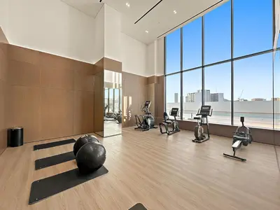 a gym with a bunch of exercise equipment in a room at FIRST CLASS Studio Touch of Luxury & Comfort in Dubai