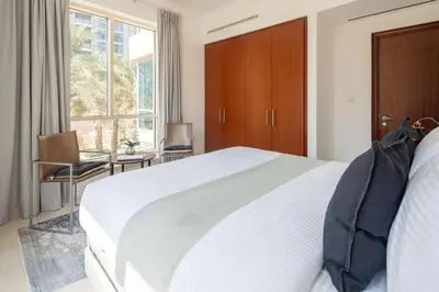 a bedroom with a white bed and a large window at Frank Porter - Al Yass Tower in Dubai