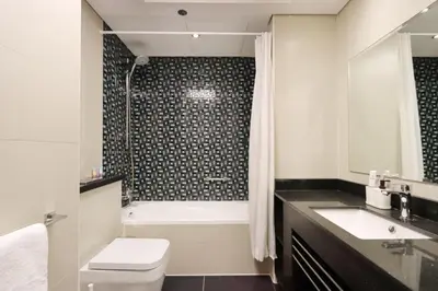 a bathroom with a tub and a toilet and a sink at Livbnb-Spacious 2 BR in Dubai Marina with Balcony in Dubai