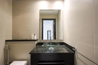 a bathroom with a sink and a mirror and a toilet at Livbnb-Spacious 2 BR in Dubai Marina with Balcony in Dubai