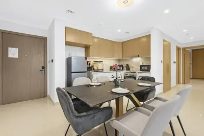 a kitchen and dining room with a table and chairs at FIRST CLASS 2BR Creek Harbour & Burj Views in Dubai