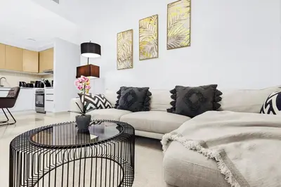 a living room with a couch and a table at FIRST CLASS 2BR Creek Harbour & Burj Views in Dubai