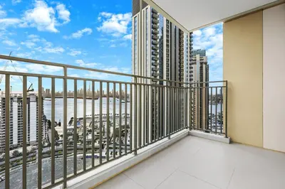 a balcony with a view of the ocean and buildings at FIRST CLASS 2BR Creek Harbour & Burj Views in Dubai