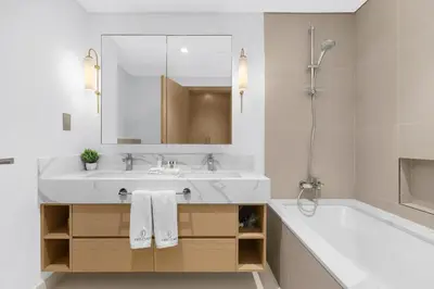 a white bathroom with a sink and a tub and a sink at FIRST CLASS 2BR Creek Harbour & Burj Views in Dubai