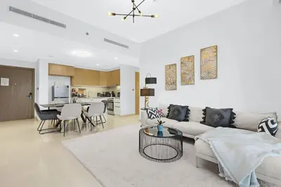 a living room with a couch and a table at FIRST CLASS 2BR Creek Harbour & Burj Views in Dubai