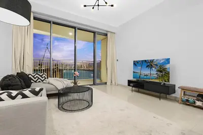 a living room with a couch and a table at FIRST CLASS 2BR Creek Harbour & Burj Views in Dubai