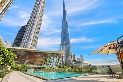 a view of the burj khalifa from a hotel with a swimming pool at FIRST CLASS 2BR Burj Khalifa & Fountain view in Dubai