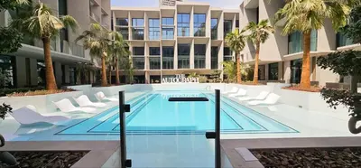 a swimming pool in the middle of a building at Modern Studio by Czechin JVC Prime Location in Dubai