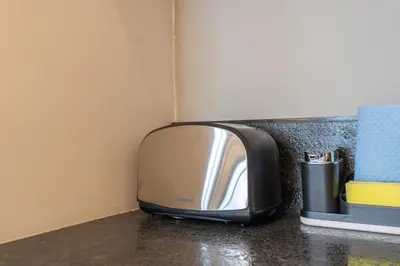 a microwave sitting on top of a counter at Modern Studio by Czechin JVC Prime Location in Dubai