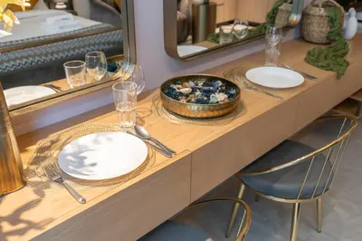 a table with a bowl of food and two mirrors at Modern Studio by Czechin JVC Prime Location in Dubai
