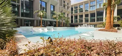a swimming pool in front of a building at Modern Studio by Czechin JVC Prime Location in Dubai