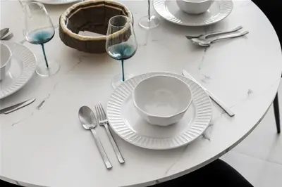 a white table with white plates and silverware on it at 1BR Summer 4 Direct Beach Access in Dubai