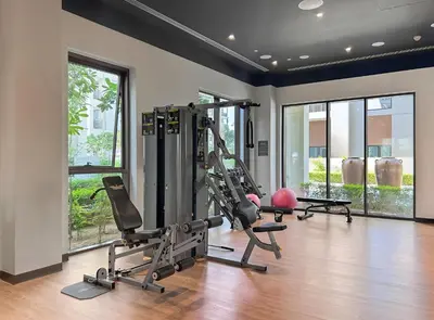 a gym with treadmills and elliptical machines at 1BR Summer 4 Direct Beach Access in Dubai