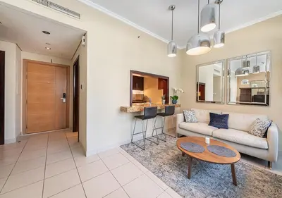 a living room with a couch and a table at Luxurious Studio in Downtown Dubai in Dubai