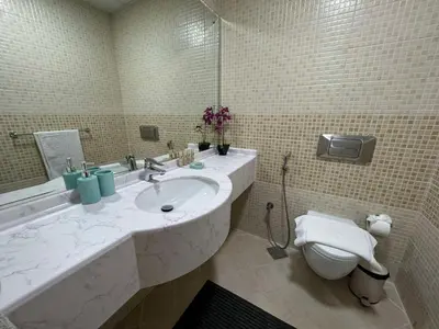 a bathroom with a sink and a toilet at Spacious and Family Friendly l 3BHK Full Apartment Access in Dubai