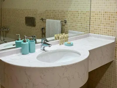 a bathroom sink with two blue cups on it at Spacious and Family Friendly l 3BHK Full Apartment Access in Dubai