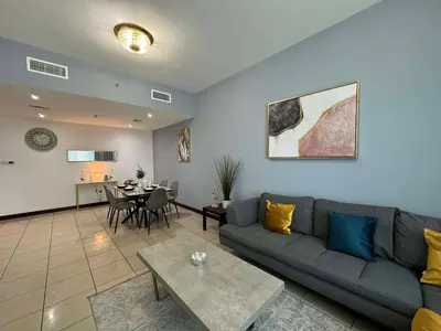 a living room with a couch and a table at Spacious and Family Friendly l 3BHK Full Apartment Access in Dubai