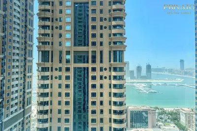 a tall building with a view of the water at Spacious and Family Friendly l 3BHK Full Apartment Access in Dubai