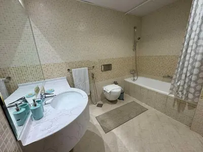 a bathroom with a sink and a toilet and a tub at Spacious and Family Friendly l 3BHK Full Apartment Access in Dubai