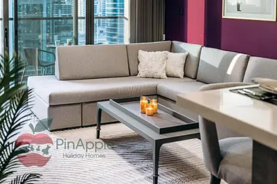 a living room with a couch and a table at Royal style New 1BR with a view in Dubai