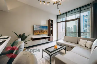 a living room with a couch and a tv at Royal style New 1BR with a view in Dubai