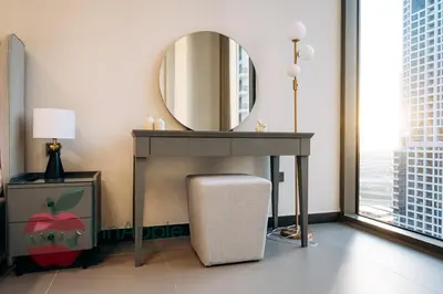 a dressing table with a mirror and a stool under it at Royal style New 1BR with a view in Dubai