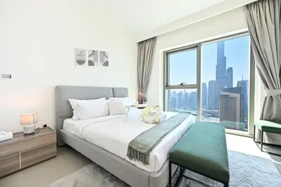 a bedroom with a large bed and a large window at Burj Khalifa View, Luxury Two-Bedroom Residence, PlayStation 5, Swimming Pool and Fitness Center in Dubai
