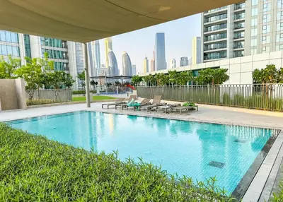 a large swimming pool in a city with buildings at Burj Khalifa View, Luxury Two-Bedroom Residence, PlayStation 5, Swimming Pool and Fitness Center in Dubai