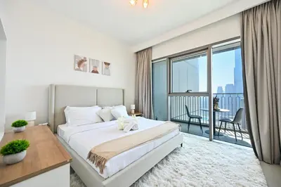 a bedroom with a large bed and a balcony at Burj Khalifa View, Luxury Two-Bedroom Residence, PlayStation 5, Swimming Pool and Fitness Center in Dubai