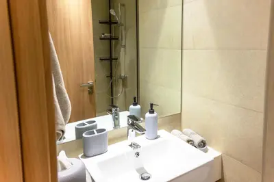 a bathroom with a sink and a mirror and a toilet at Modern Studio in Azizi Riviera, Meydan in Dubai