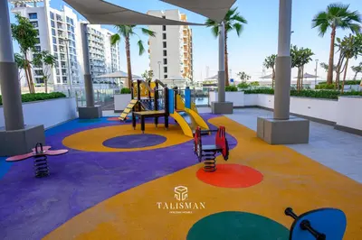 a childrens playground with a slide and play equipment at Modern Studio in Azizi Riviera, Meydan in Dubai