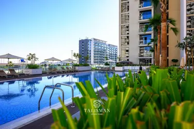 a swimming pool in a city with buildings at Modern Studio in Azizi Riviera, Meydan in Dubai