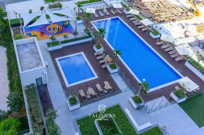 an overhead view of a swimming pool with chairs and a pool at Modern Studio in Azizi Riviera, Meydan in Dubai