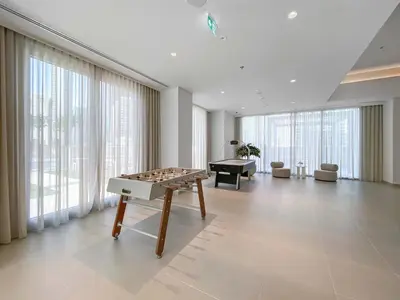 a large room with a table with a game at Silkhaus Cozy 1BDR at Forte Tower in Emaar Downtown in Dubai