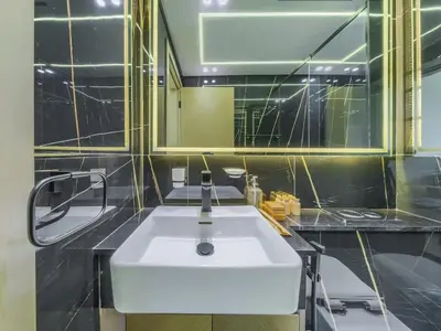 a bathroom with a white sink and a mirror at TRPS - Binghatti Nova, Jumeirah Village Circle - Premium 1BR with Great Amenities in Dubai