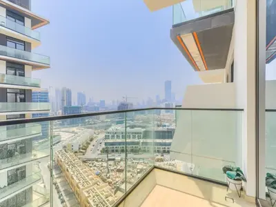 a glass balcony with a view of a city at TRPS - Binghatti Nova, Jumeirah Village Circle - Premium 1BR with Great Amenities in Dubai