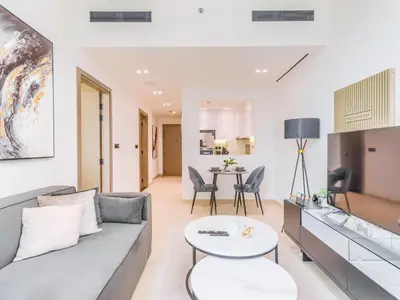 a living room with a couch and a table at TRPS - Binghatti Nova, Jumeirah Village Circle - Premium 1BR with Great Amenities in Dubai