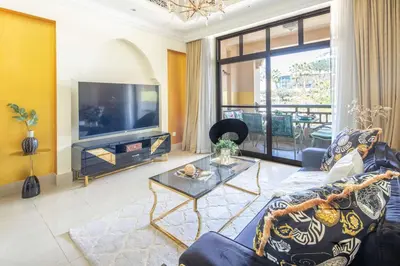 a living room with a couch and a tv at Frank Porter - Tejar Tower in Dubai