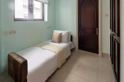 a bedroom with a bed and a window and a door at Frank Porter - Tejar Tower in Dubai