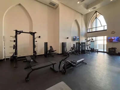 a gym with several exercise equipment in a room at Frank Porter - Tejar Tower in Dubai