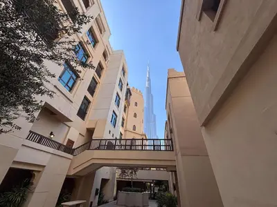 a view of the burj khalifa from an alley between buildings at Frank Porter - Tejar Tower in Dubai
