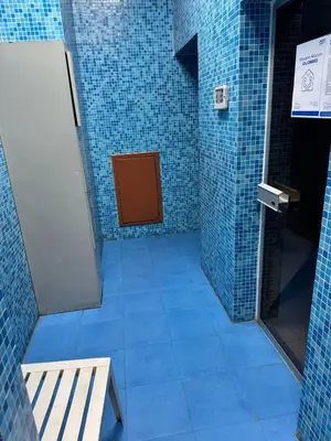 a blue tiled hallway with a door in a bathroom at Supper holly days home in Dubai