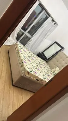 an overhead view of a bed in a room with a window at Supper holly days home in Dubai