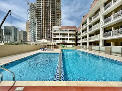 a large swimming pool in the middle of a building at Homes2Retreat - Serene 1BR Getaway with Stunning Views in Dubai