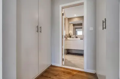 a bathroom with a mirror and a sink at GuestReady - Chic High-Rise with Canal Views in Dubai