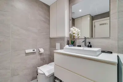a bathroom with a sink and a toilet at GuestReady - Chic High-Rise with Canal Views in Dubai